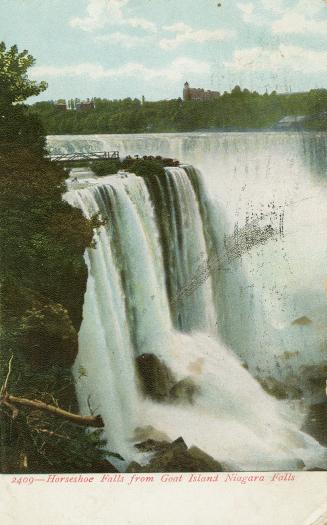 Photograph of waterfalls cascading over cliff. The picture has a white border.