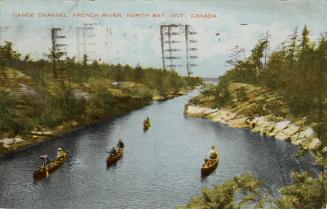 Colorized photograph of four canoes being paddled on a river with rocks and bush on each side o…