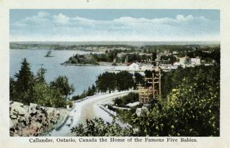 Colorized photograph of a road running into a small settlement in the bush.