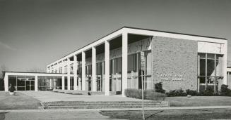 Picture of modern library building with large windows and pillars. 
