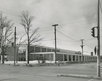 Picture of modern library building with large windows and pillars. 