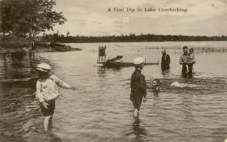 Black and white photograph of children and adults wading in a body of water with weeds.