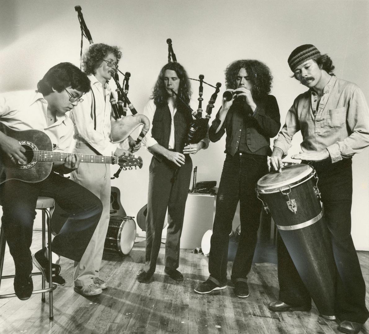 five musicians playing instruments, whole body image, from left guitar player, two bagpipers, h…