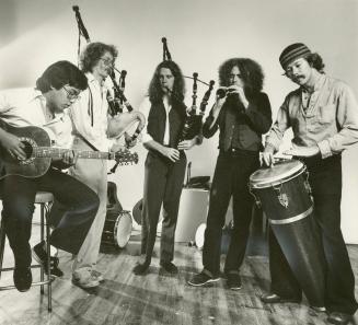 five musicians playing instruments, whole body image, from left guitar player, two bagpipers, h…