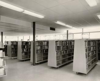 Picture of a 1950's library interior showing shelving. 