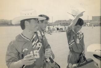 e young men on soccer pitch in soccer team jerseys. One has cowboy hat on head and another tips…