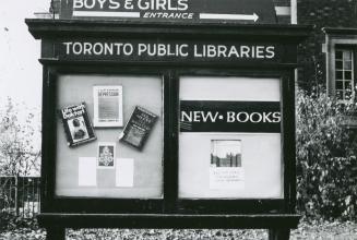 Picture of exterior library sign with poster saying library closed until December. 