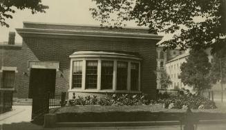 Picture of library addition showing rounded window and sign above door saying Boys and Girls Li…