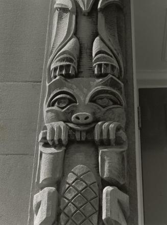 Close up of stone carving stylized totem pole. 