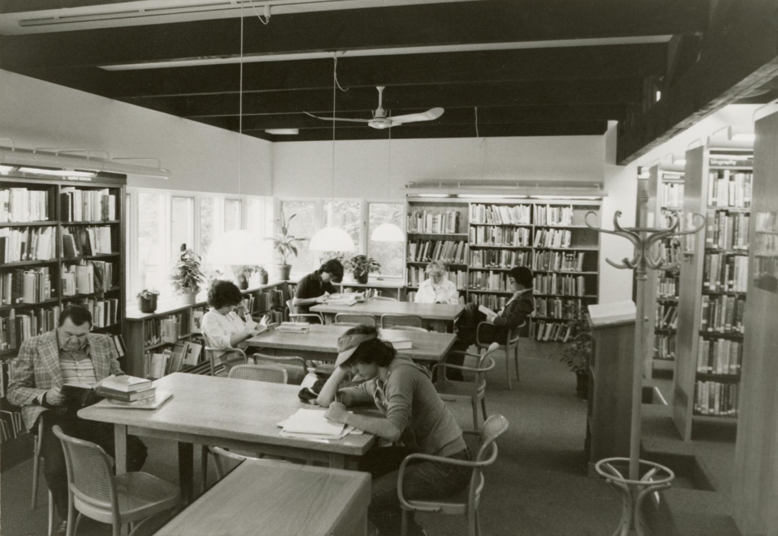 Picture of inside a library showing shelves, tables and chairs. 