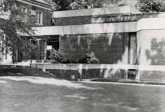 Picture of 1960s brick building extension to historic house to left. 