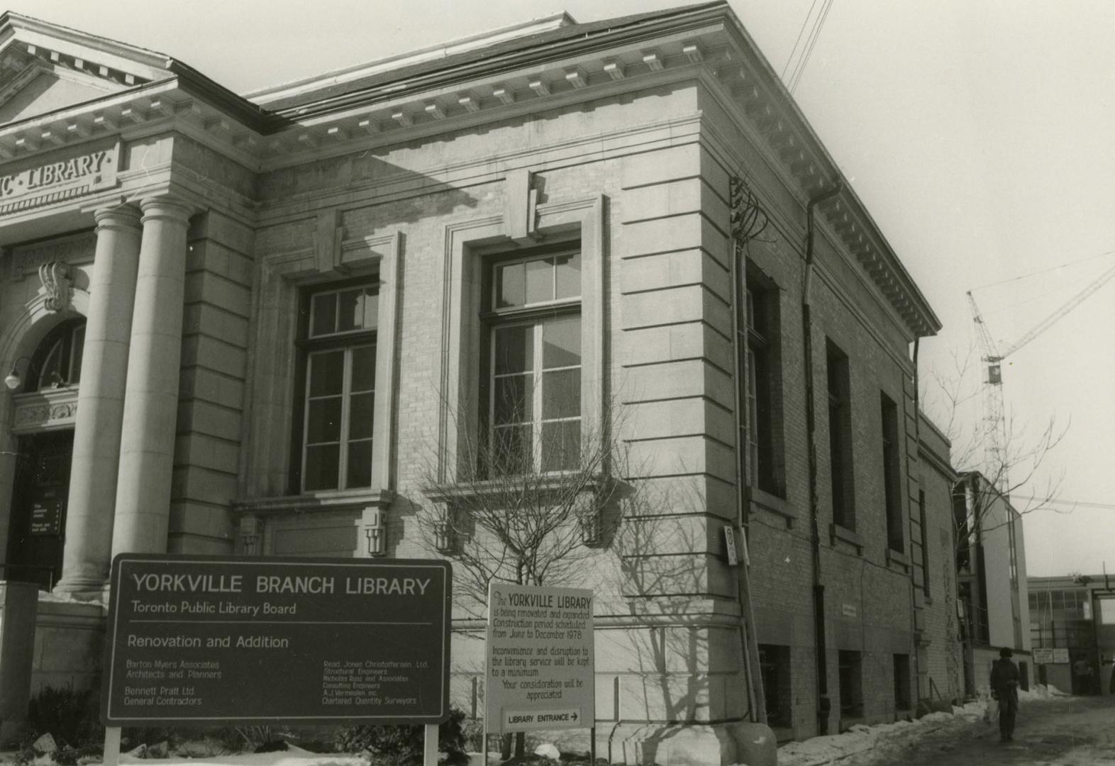 Front and side view of a one story stone library building with four pillars and portico. 