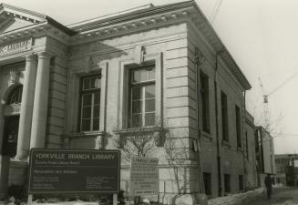 Front and side view of a one story stone library building with four pillars and portico. 