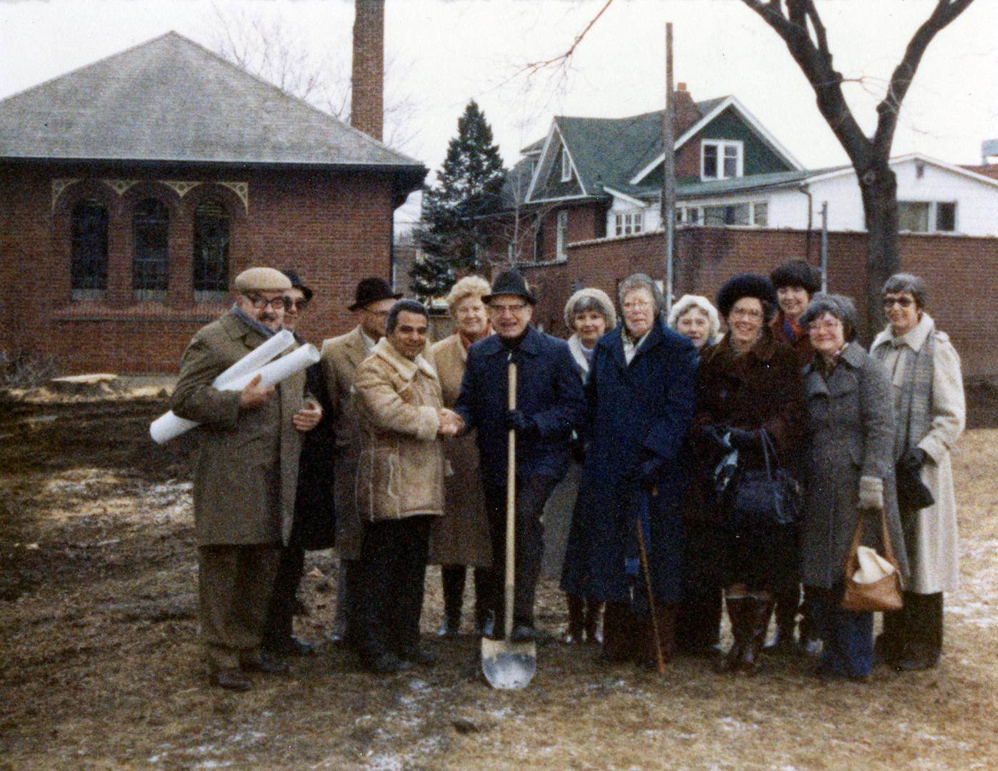 Picture of a group of people posing with shovel at a sod turning. 