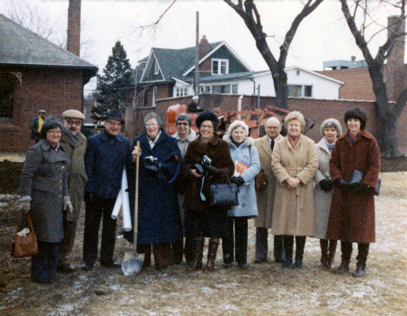 Picture of a group of people posing with shovel at a sod turning. 