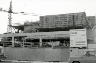 Picture of construction of library building with large sign out front. 