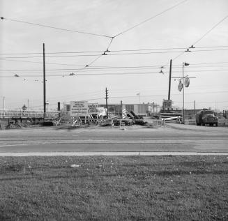 Photograph of construction of wooden bridge over railway line. 
