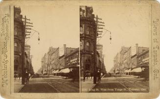 Picture looking down on a crowded street with a parade of horse drawn carriages and buggies and…