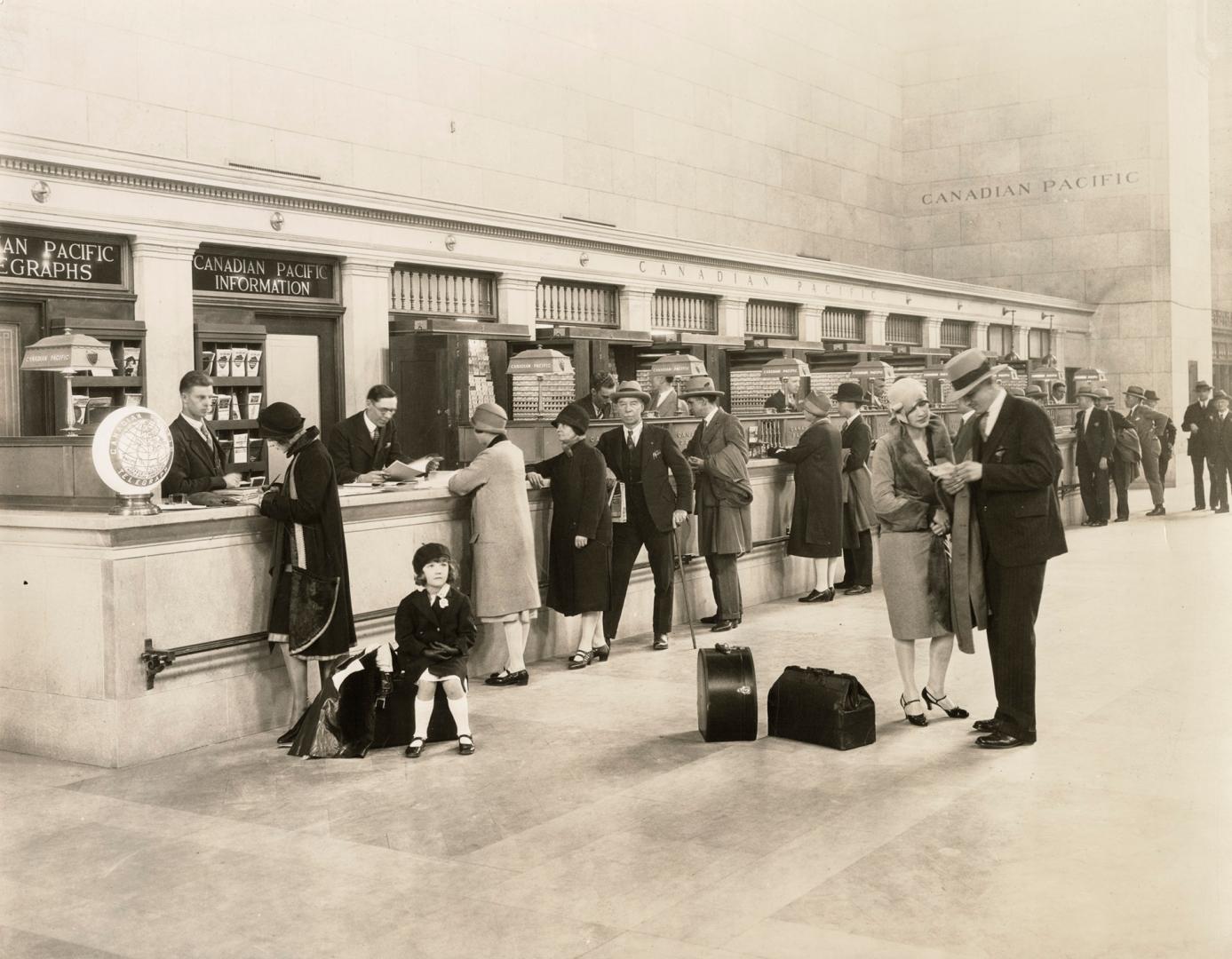 Black-and-white photograph of a long Canadian Pacific ticket counter inside Union Station, Toro…