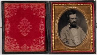 Open antique hinged photograph case; the left interior panel is lined with red velvet featuring…