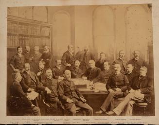 Composite sepia photograph of numerous adults posed around a table in a formal interior, some s…