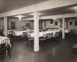 church basement set up with tables and chairs for a banquet