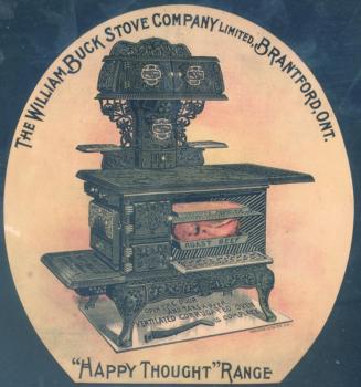 Illustration of a large, black cast-iron, ornately designed stove from the early 1900s. 