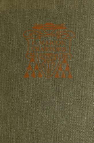 Grey book cover with a decorative orange design enclosing the author's name.