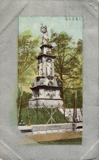 Picture of a large monument with several figures surrounded by trees. 
