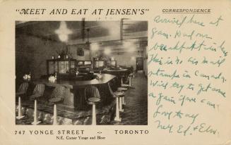 B/W postcard depicting the interior of a restaurant with fixed barstools as seating. The captio ...