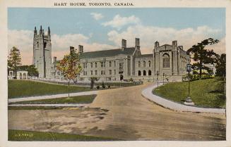 Colorized photograph of a large, gothic style collegiate building with a central tower.