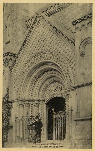 Black and whit photograph of a man standing in front of an elaborate front door to a stone buil ...