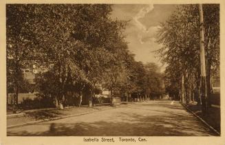 Black and white photograph of a tree lined street.