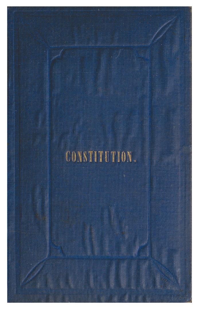 In a blue cloth hardcover, with the gold imprint 'constitution' on the front cover.